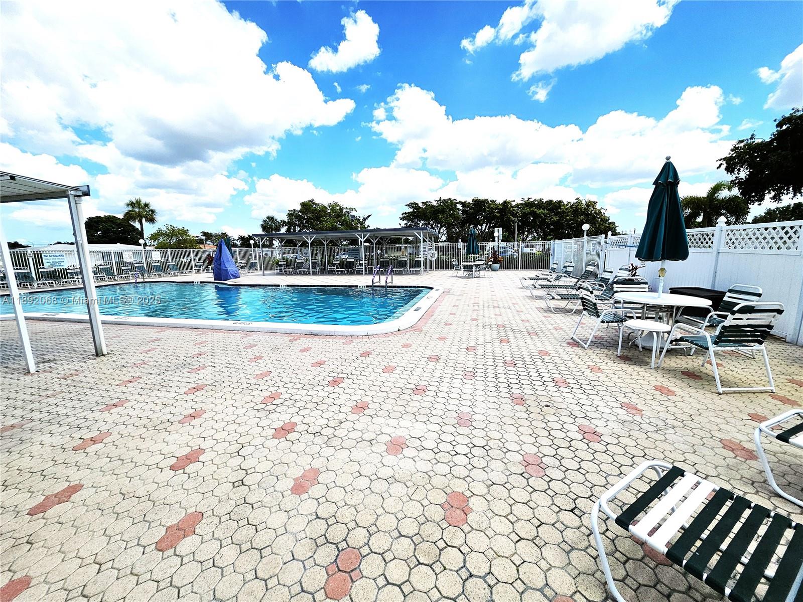 1040 Northwest 73rd Terrace Margate, FL 33063 - Photo 38 of 41 a view of a swimming pool with a lounge chairs