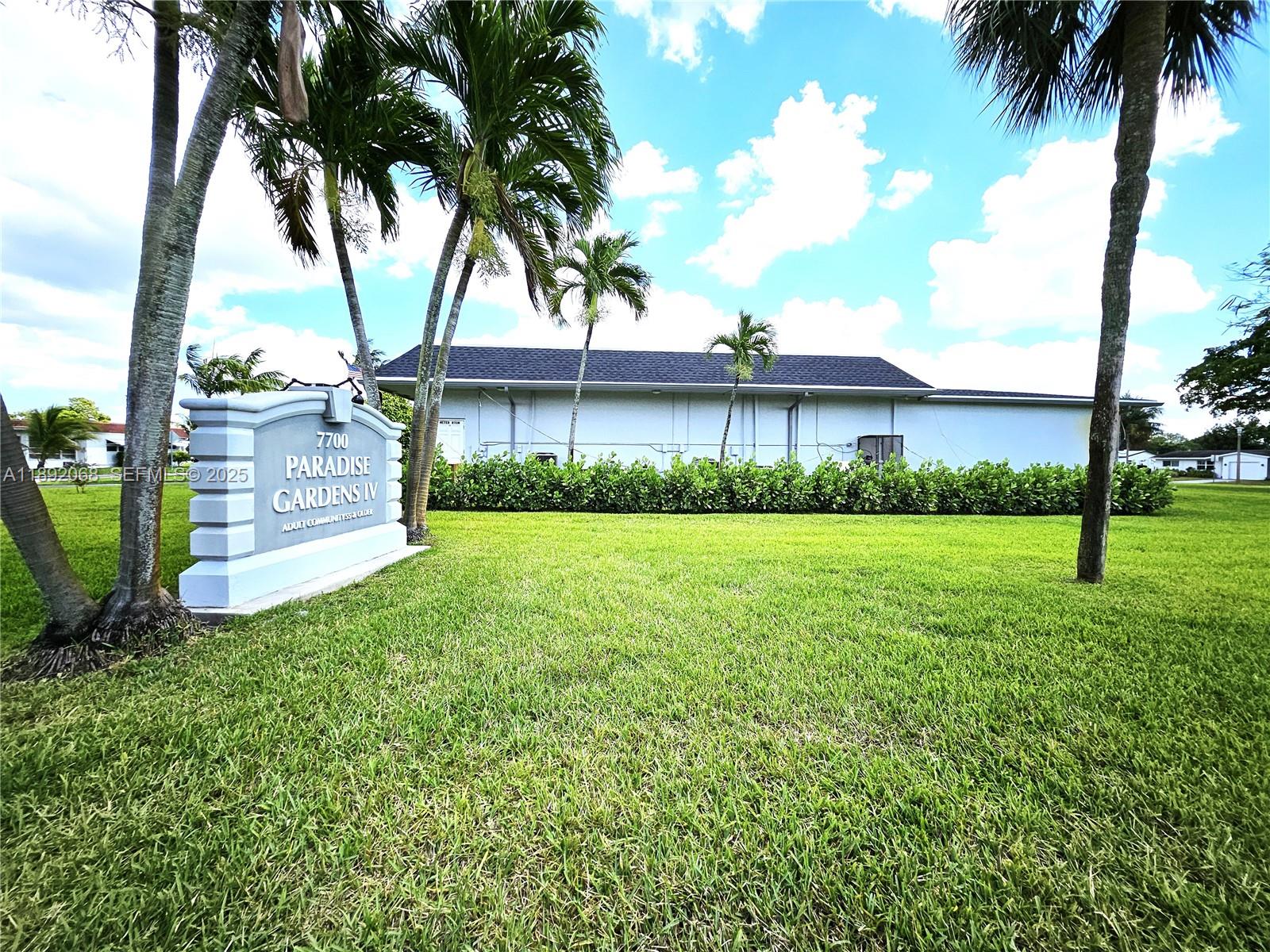 1040 Northwest 73rd Terrace Margate, FL 33063 - Photo 40 of 41 a front view of a house with a yard and garage