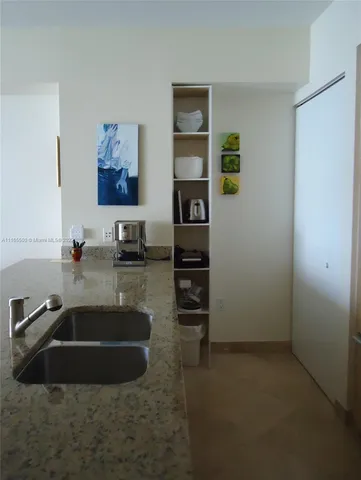 a view of a dining room with furniture and a potted plant