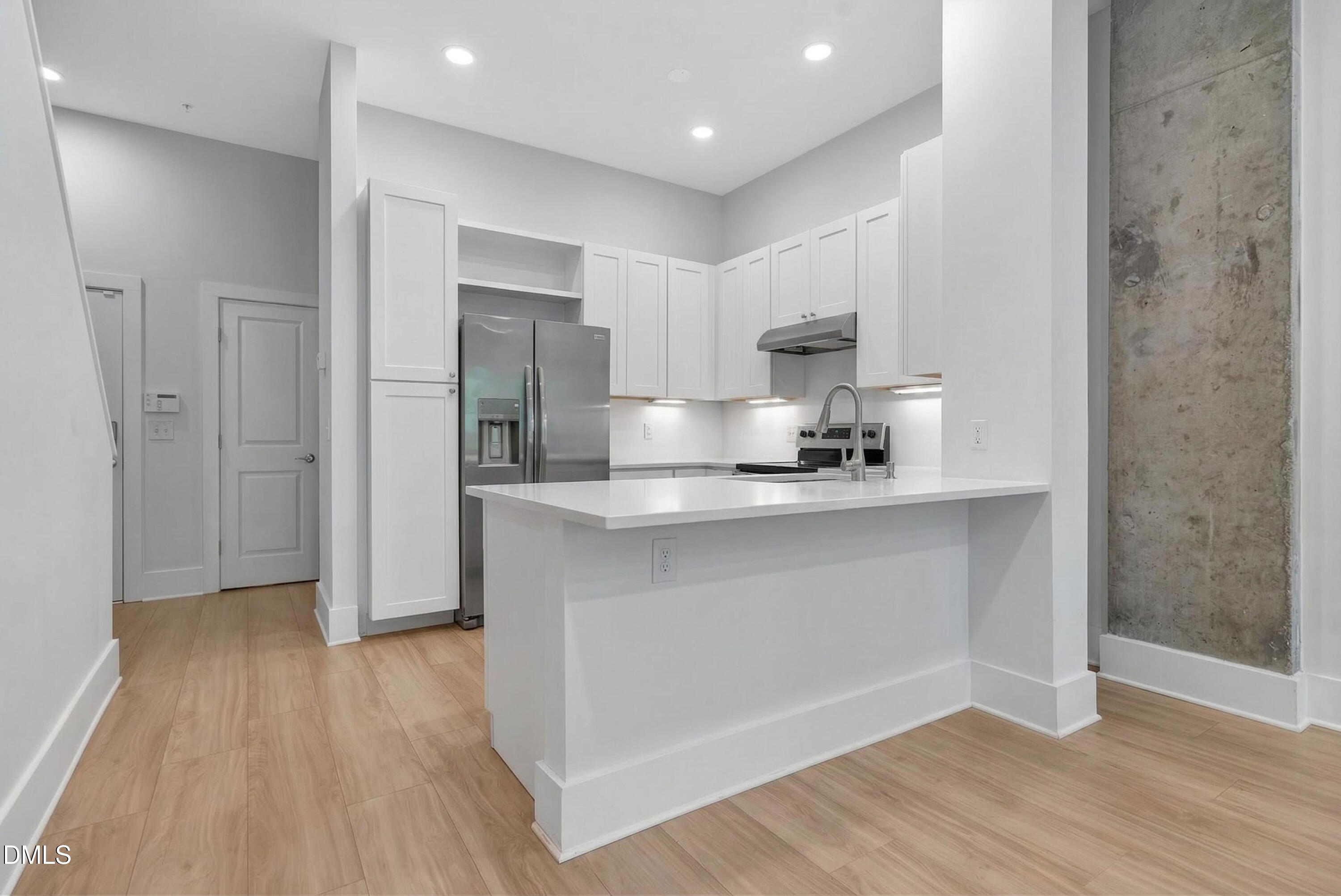 444 South Blount Street, Unit 111 Raleigh, NC 27601 - Photo 5 of 40 a kitchen with a refrigerator and a sink