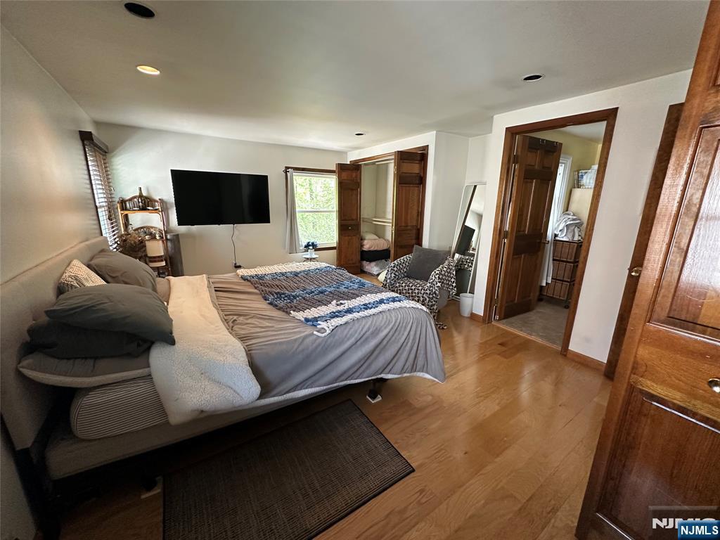 410 Burlington Road Paramus, NJ 07652 - Photo 3 of 12 a bedroom with a bed and a flat screen tv