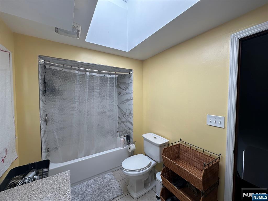 410 Burlington Road Paramus, NJ 07652 - Photo 4 of 12 a bathroom with a granite countertop toilet a sink and a shower