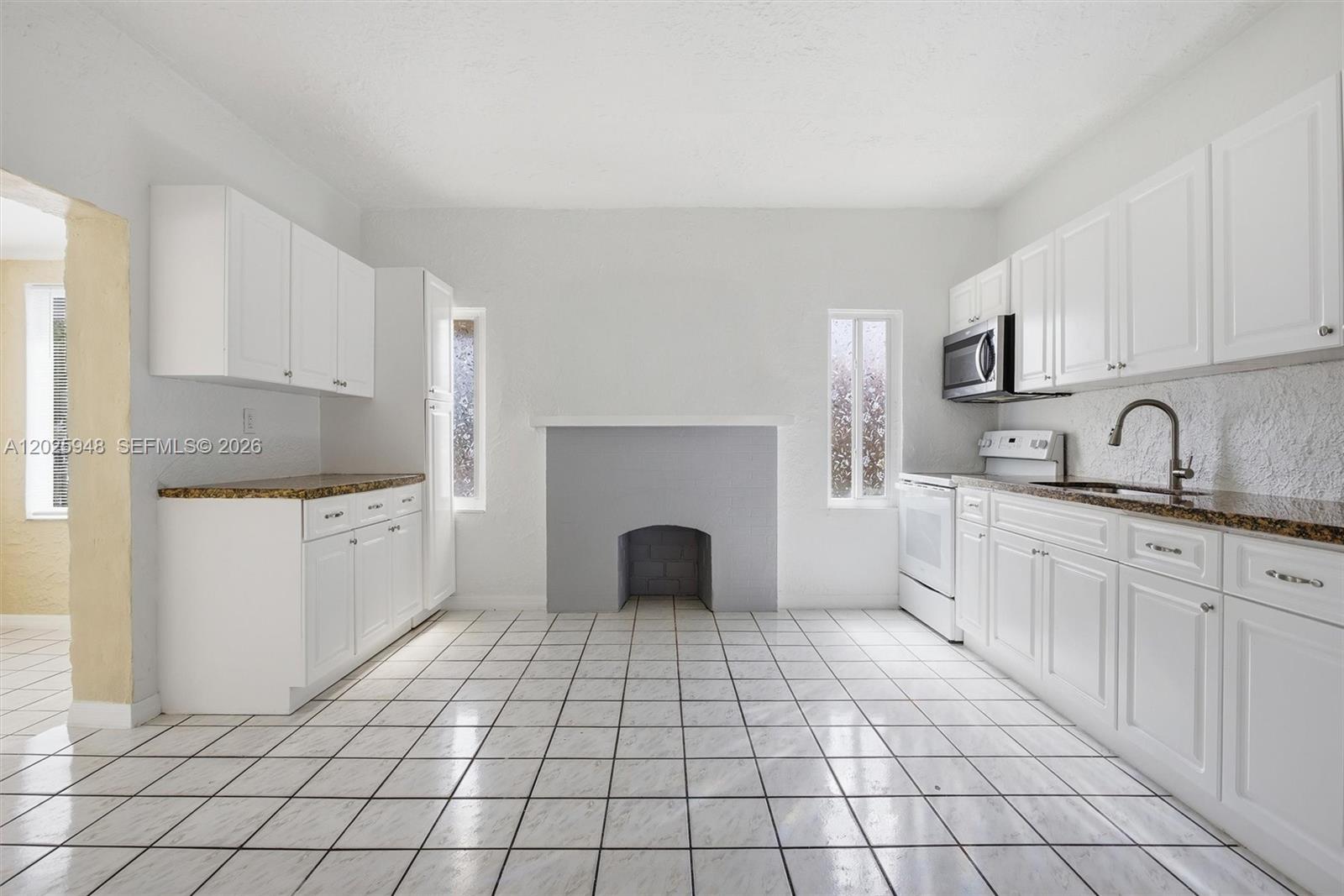 1745 Southwest 17th Street, Unit 2 Miami, FL 33145 - Photo 8 of 32 a kitchen with a sink a stove and cabinets