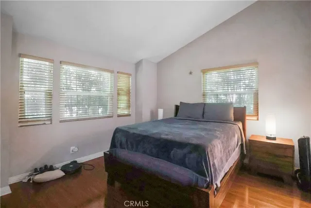 a bedroom with a bed and windows