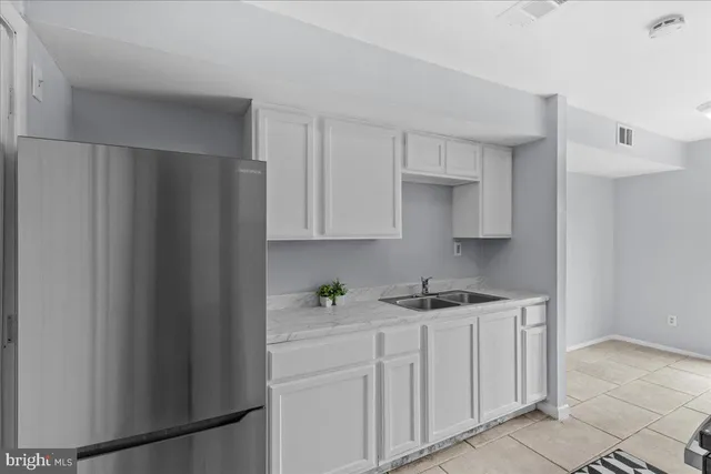 a kitchen with stainless steel appliances white cabinets and a sink