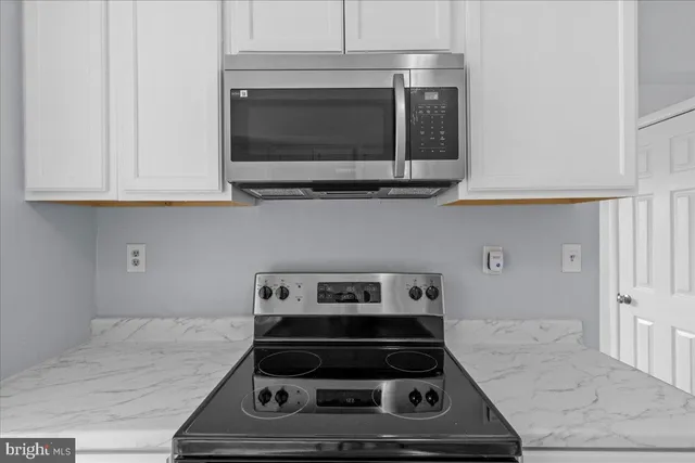 a kitchen with a stove and a microwave