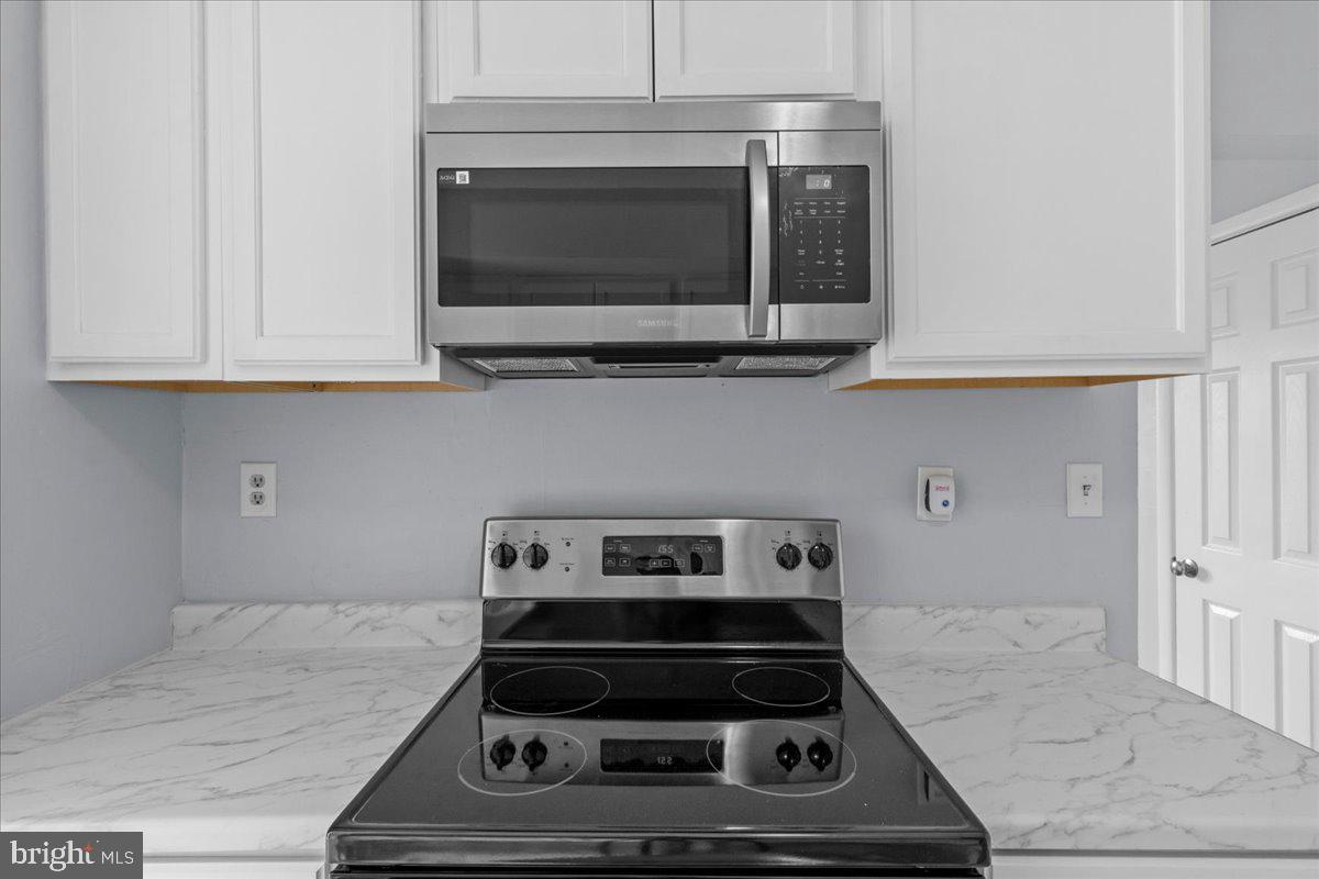 10 Longbow Court Sicklerville, NJ 08081 - Photo 12 of 26 a kitchen with a stove and a microwave