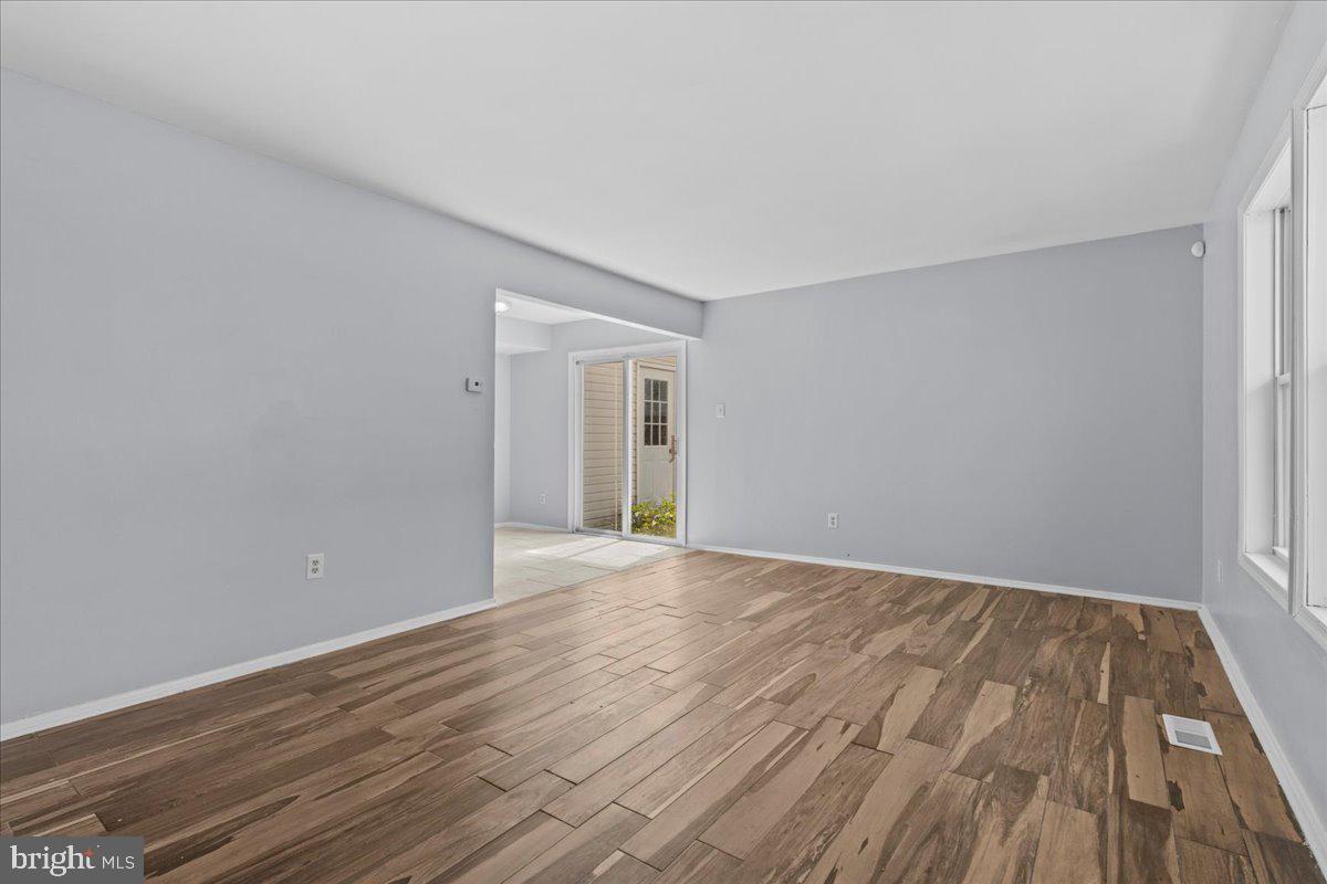 10 Longbow Court Sicklerville, NJ 08081 - Photo 4 of 26 a view of an empty room with wooden floor and a window