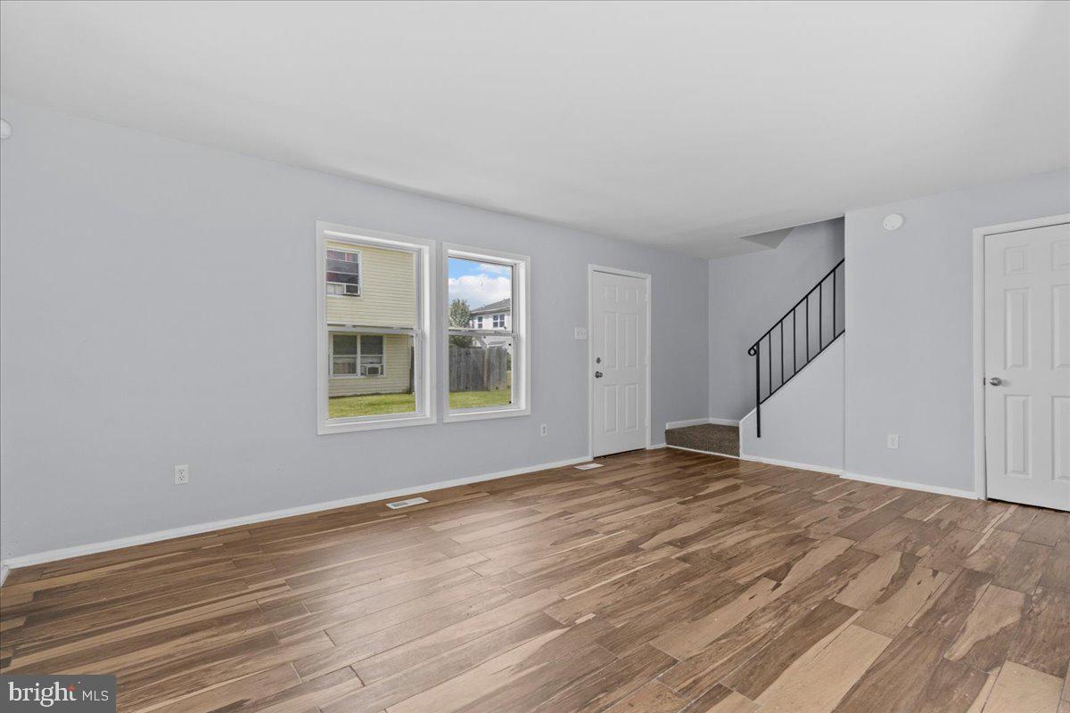 10 Longbow Court Sicklerville, NJ 08081 - Photo 5 of 26 a view of an empty room with wooden floor and a window