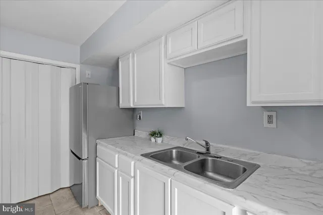 a kitchen with stainless steel appliances granite countertop a refrigerator sink and cabinets