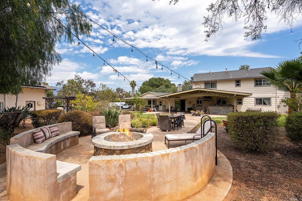 2430 Geyer Lane Alpine, CA 91901 - Photo 37 of 60 a view of a patio with table and chairs potted plants with wooden floor