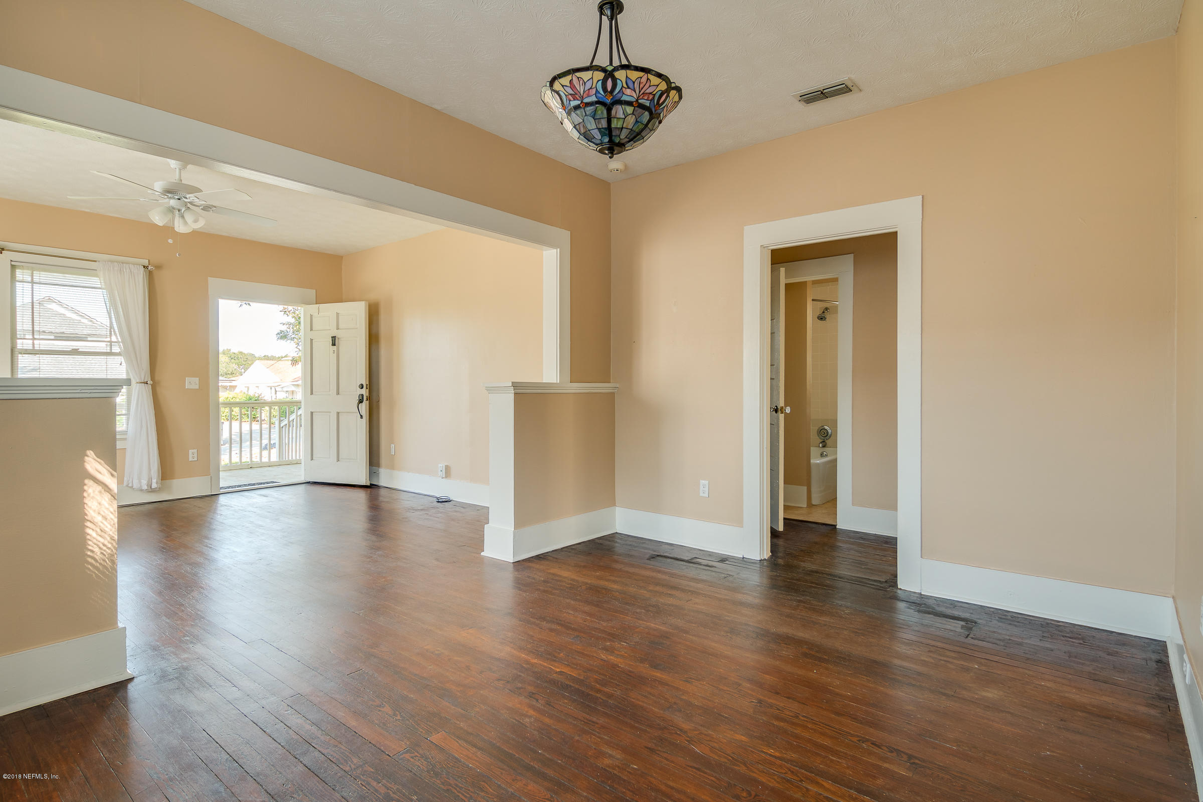 1509 Mayfair Road Jacksonville, FL 32207 - Photo 13 of 22 a view of an empty room with wooden floor and a window