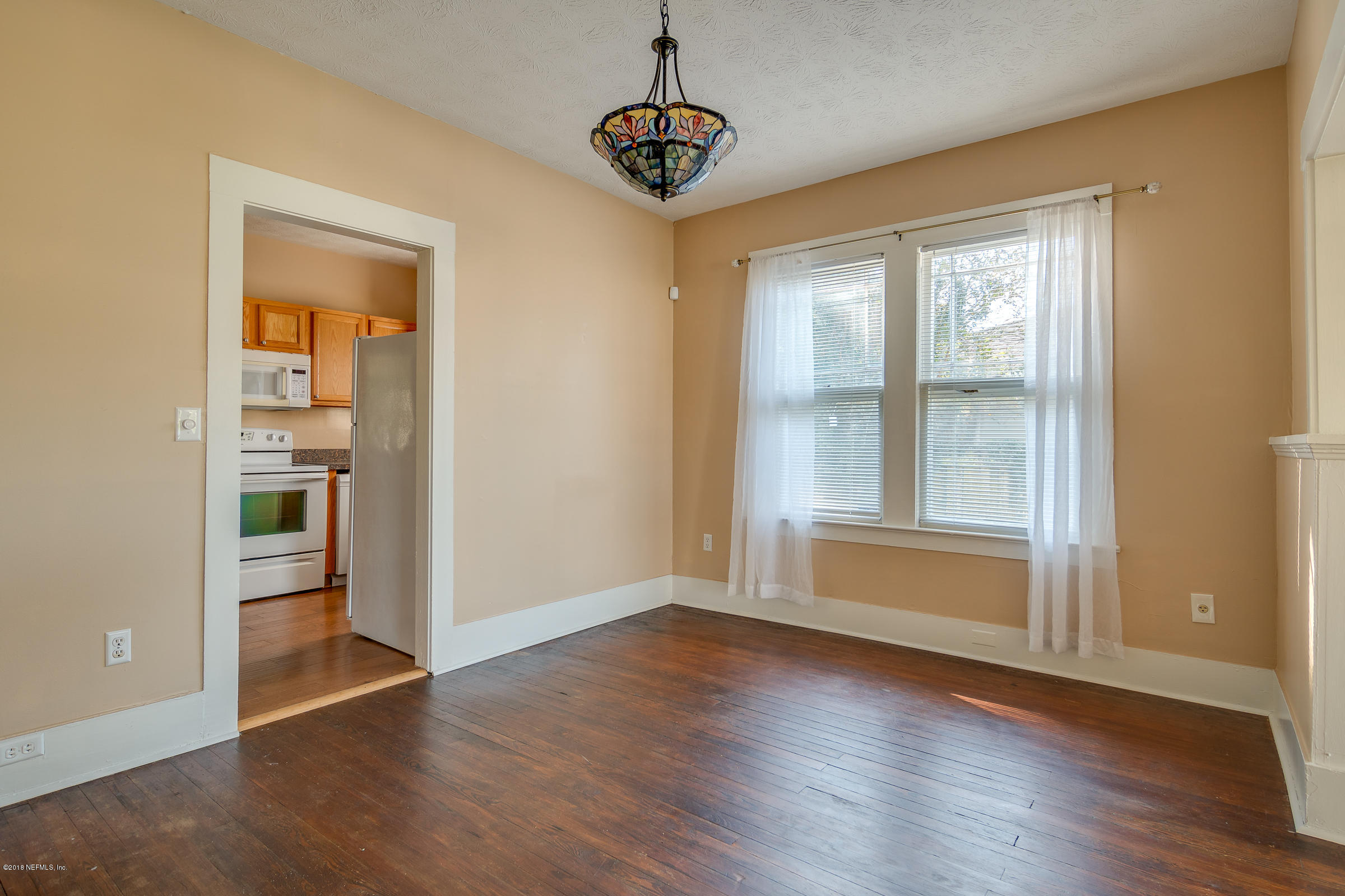 1509 Mayfair Road Jacksonville, FL 32207 - Photo 14 of 22 an empty room with wooden floor wooden floor and windows