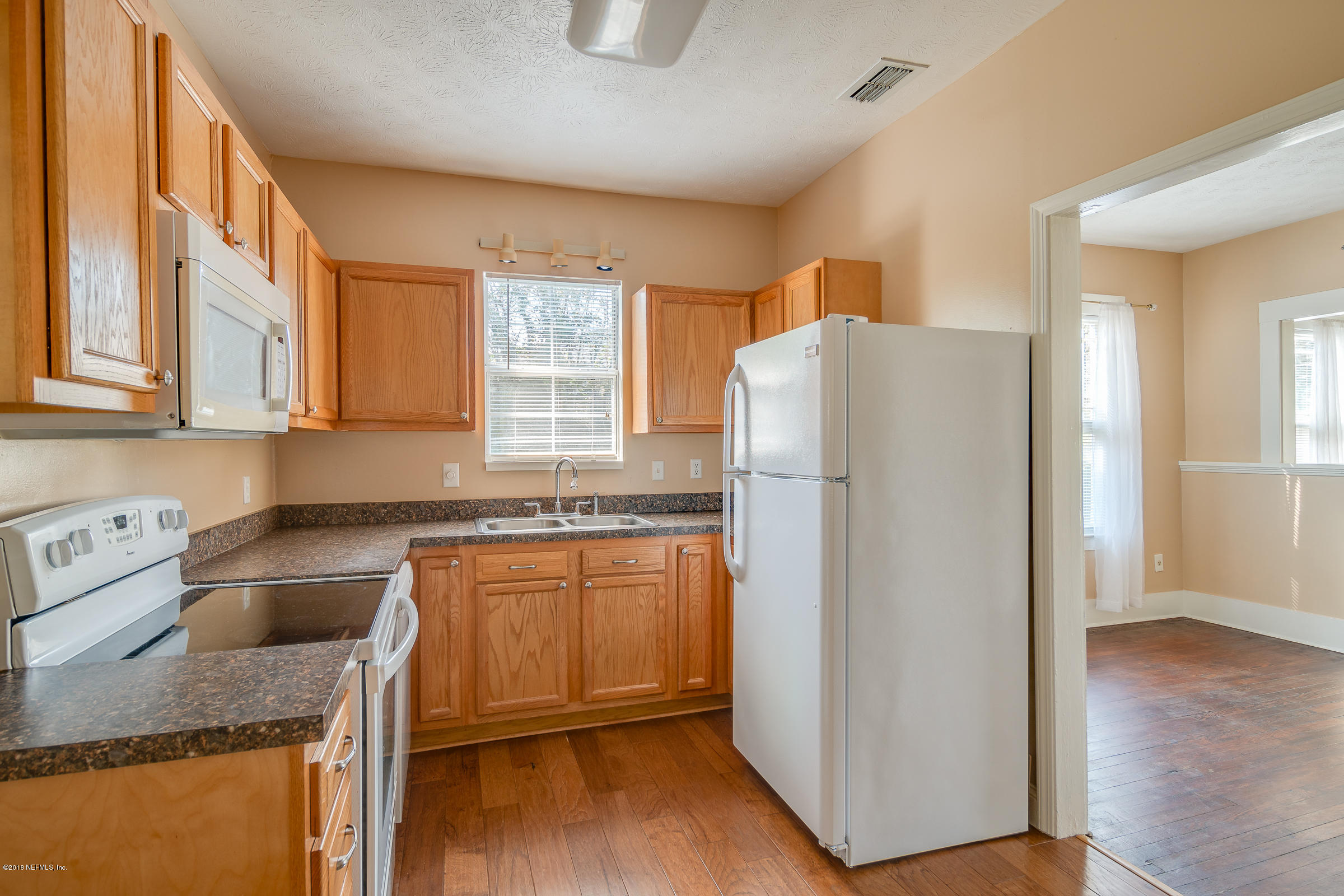 1509 Mayfair Road Jacksonville, FL 32207 - Photo 17 of 22 a kitchen with granite countertop a refrigerator and a sink