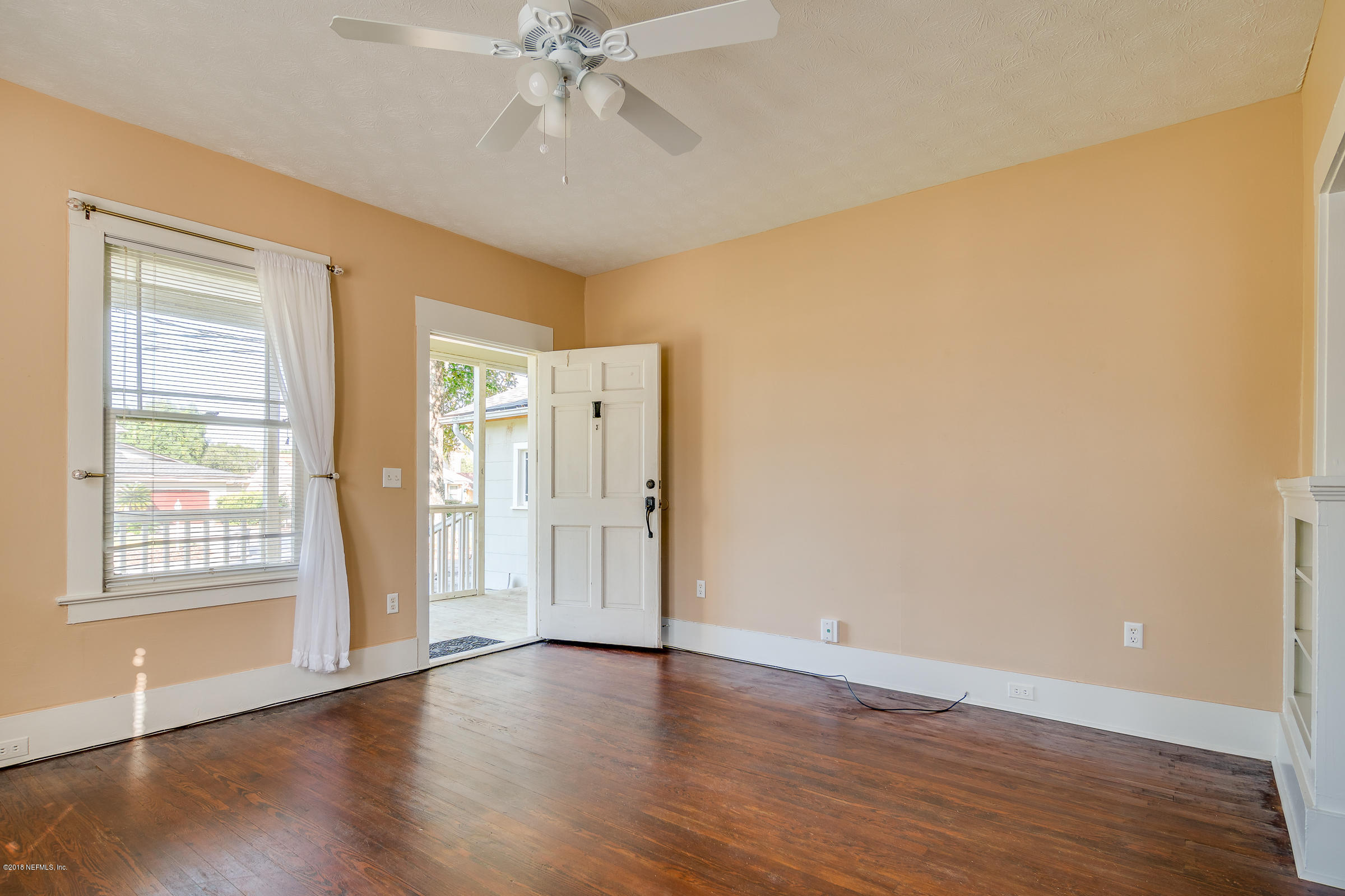 1509 Mayfair Road Jacksonville, FL 32207 - Photo 20 of 22 a view of an empty room with wooden floor and a window