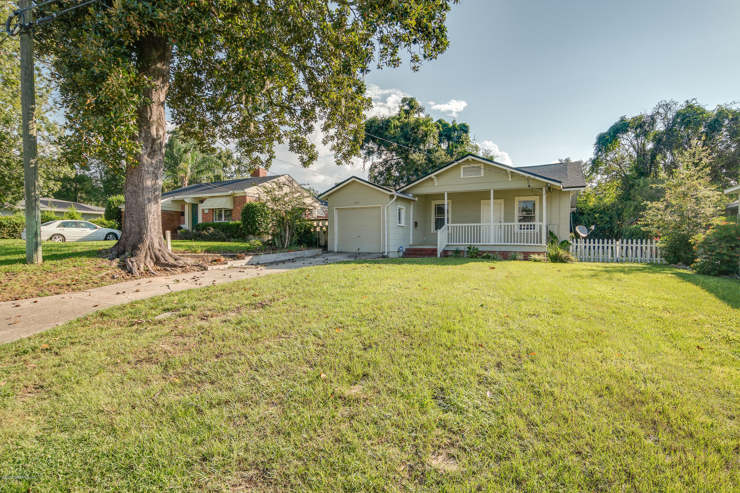 1509 Mayfair Road Jacksonville, FL 32207 - Photo 2 of 22 a front view of a house with a yard and trees