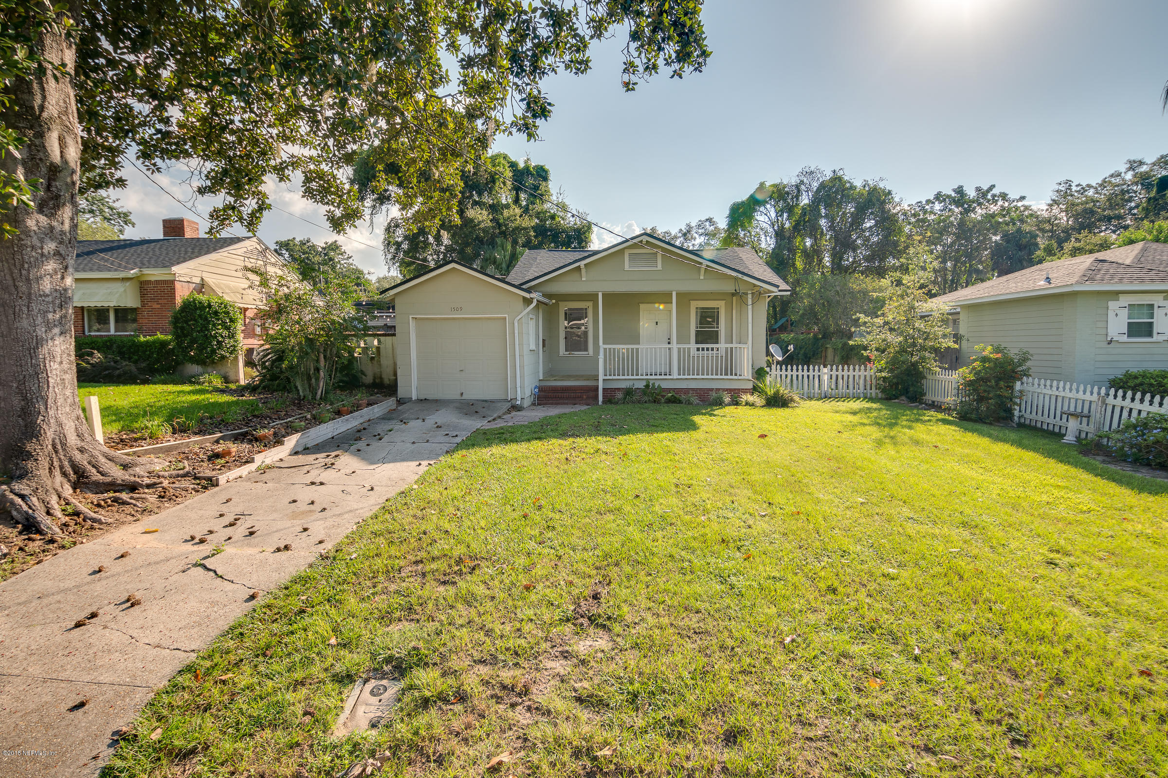 1509 Mayfair Road Jacksonville, FL 32207 - Photo 4 of 22 a view of a house with a yard and large trees