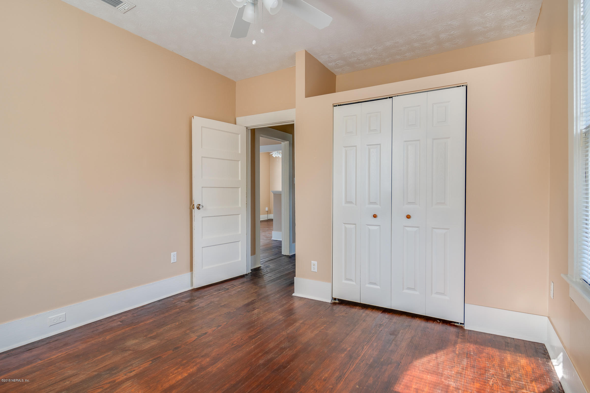 1509 Mayfair Road Jacksonville, FL 32207 - Photo 9 of 22 an empty room with wooden floor