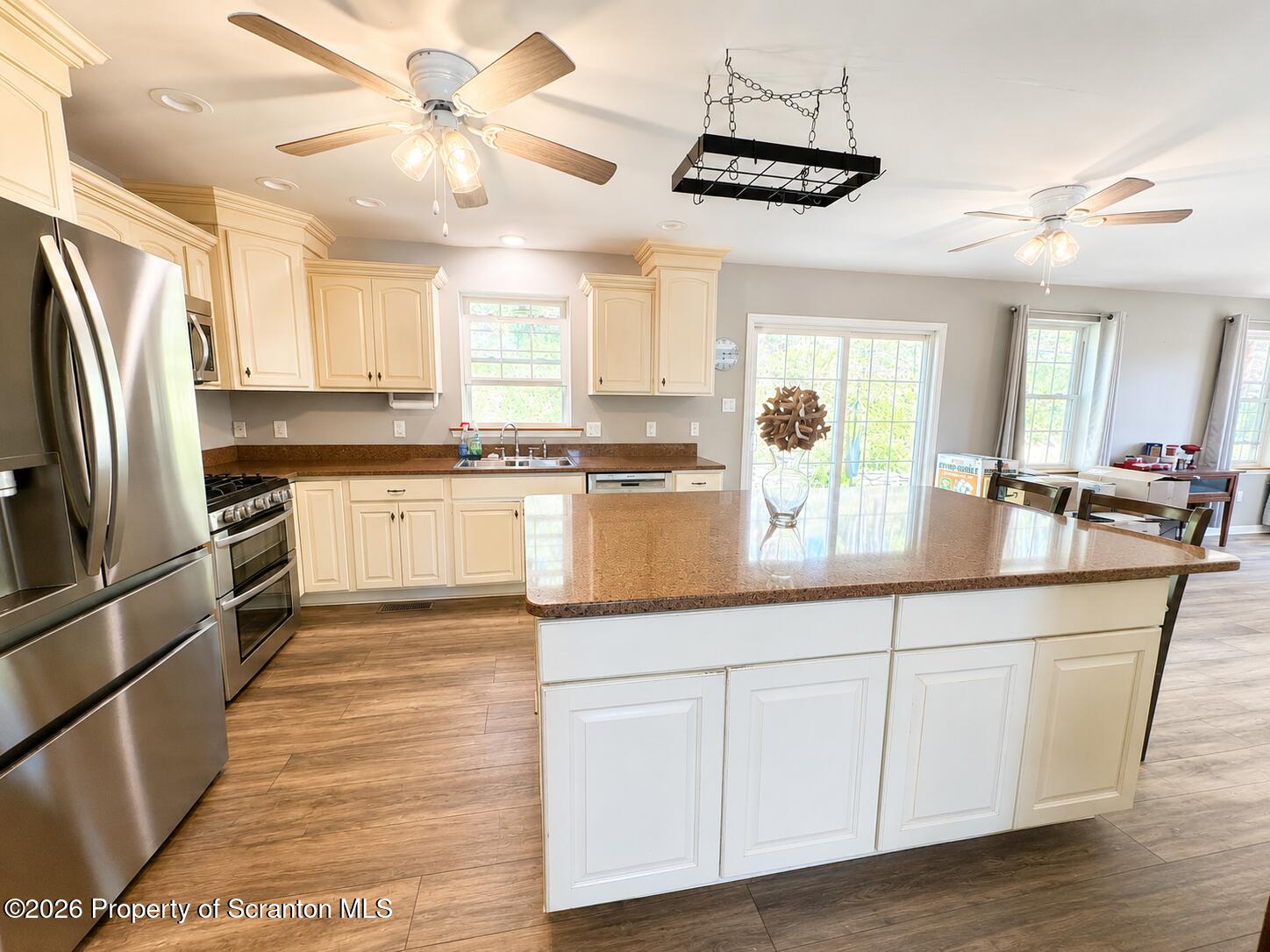 155 Baylor Road Nicholson, PA 18446 - Photo 25 of 53 a kitchen with stainless steel appliances granite countertop a refrigerator a sink dishwasher a stove and white cabinets with wooden floor