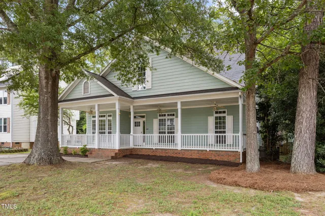 a view of a house with a large window and large tree