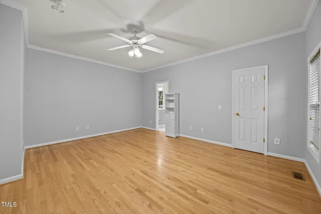 a view of an empty room with wooden floor