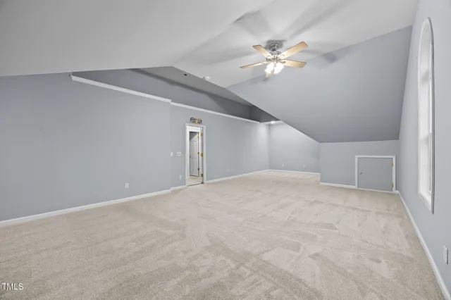 a view of a livingroom with a ceiling fan and carpet