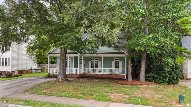 a view of a house with a yard porch and sitting area