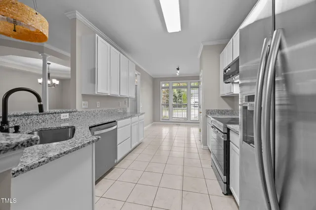 a kitchen with stainless steel appliances granite countertop a refrigerator and a sink