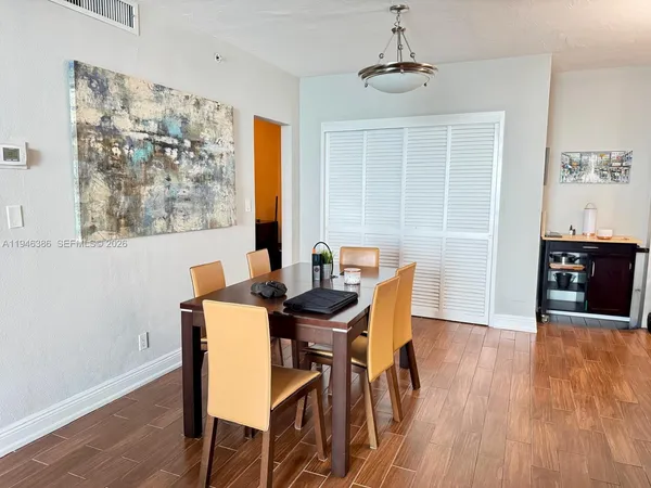 a view of a dining room with furniture and wooden floor