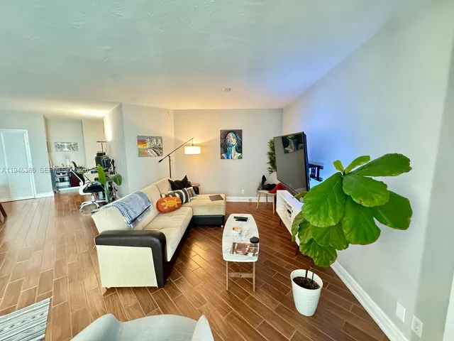a living room with furniture and a potted plant