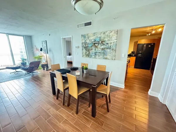 a view of a dining room with furniture and wooden floor