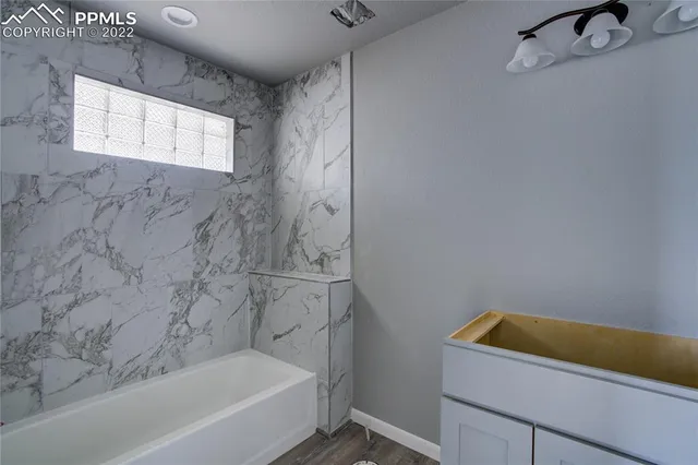 a bathroom with a bathtub and shower