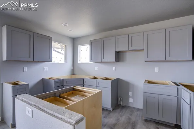 a kitchen with cabinets and window