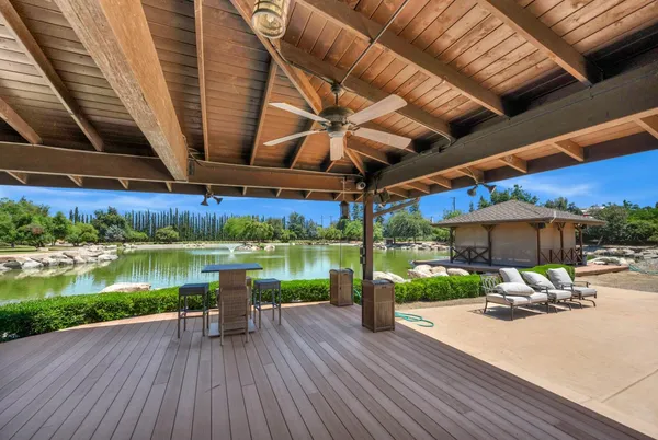 a view of a lake from balcony with furniture