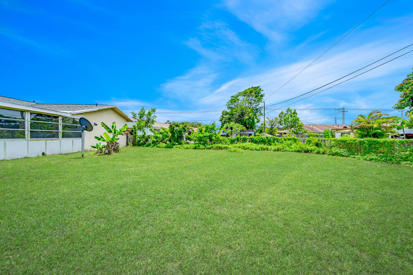 22243 Southwest 64th Way Boca Raton, FL 33428 - Photo 36 of 47 a view of a house with a backyard and a garden