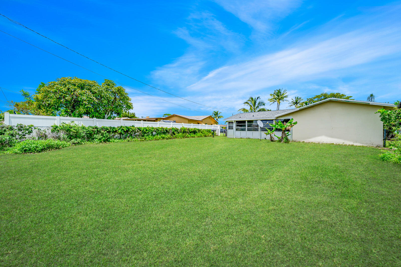 22243 Southwest 64th Way Boca Raton, FL 33428 - Photo 38 of 47 a backyard of a house with lots of green space and plants