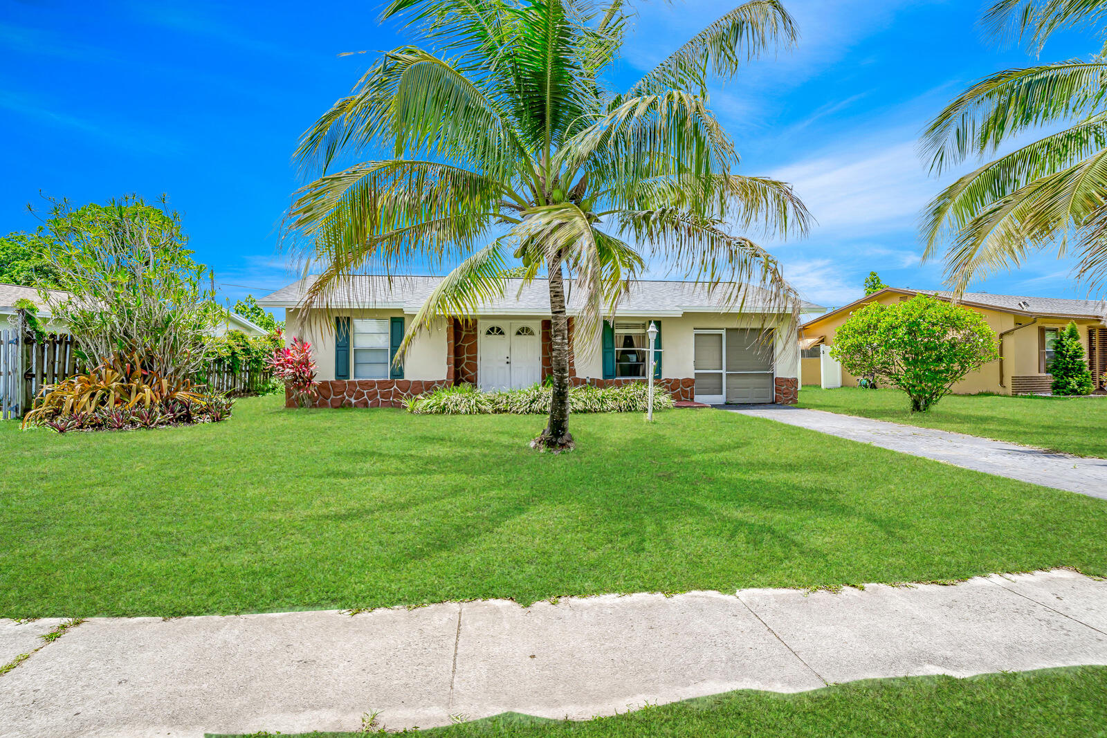 22243 Southwest 64th Way Boca Raton, FL 33428 - Photo 4 of 47 a house view with a garden space