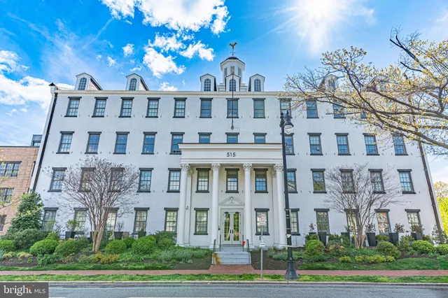 a view of a big building with a yard