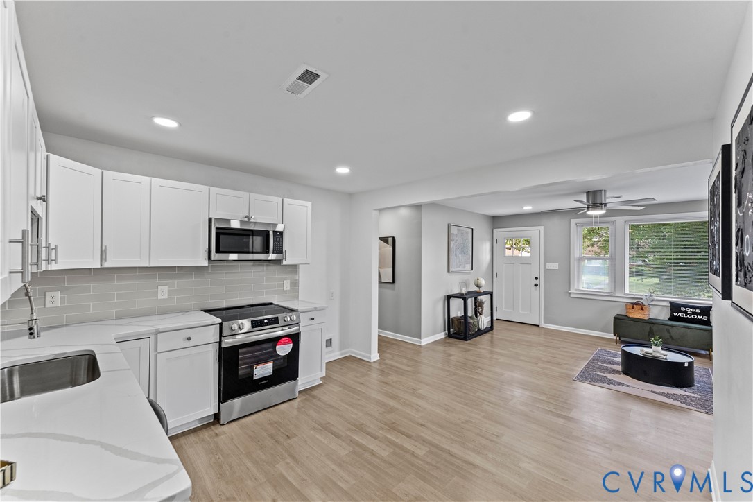 2000 Cleary Road Richmond, VA 23223 - Photo 13 of 28 Kitchen featuring white cabinetry, backsplash, sta