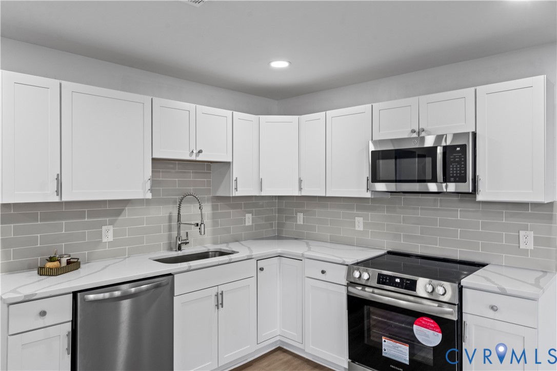 2000 Cleary Road Richmond, VA 23223 - Photo 14 of 28 Kitchen with stainless steel appliances, white cab