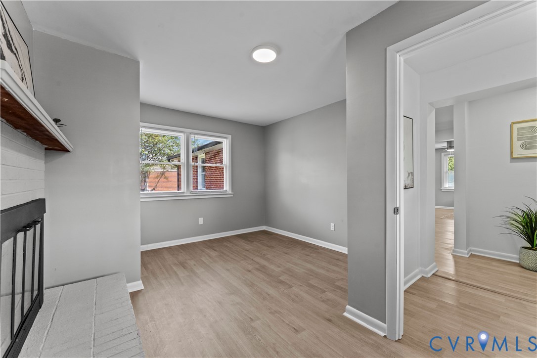 2000 Cleary Road Richmond, VA 23223 - Photo 18 of 28 Spare room with light wood-style floors and a fire