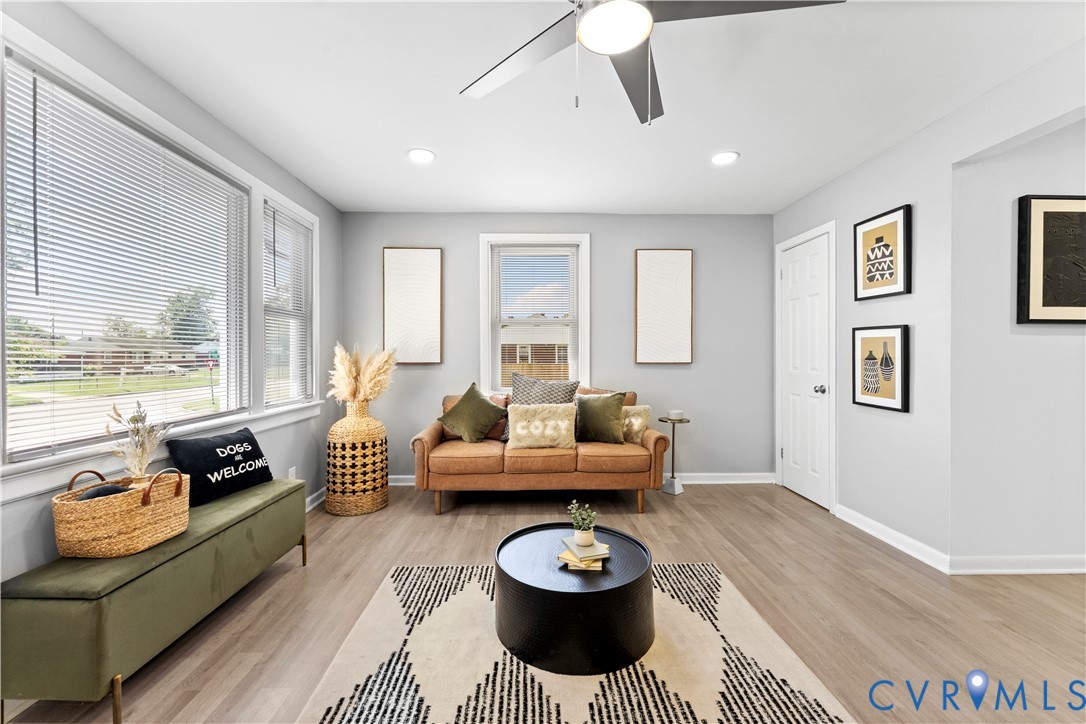 Living area with light wood-type flooring, ceiling
