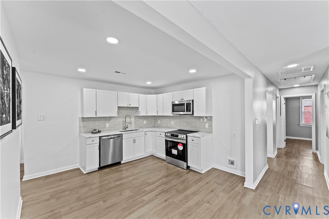 2000 Cleary Road Richmond, VA 23223 - Photo 10 of 28 Kitchen with tasteful backsplash, white cabinets,