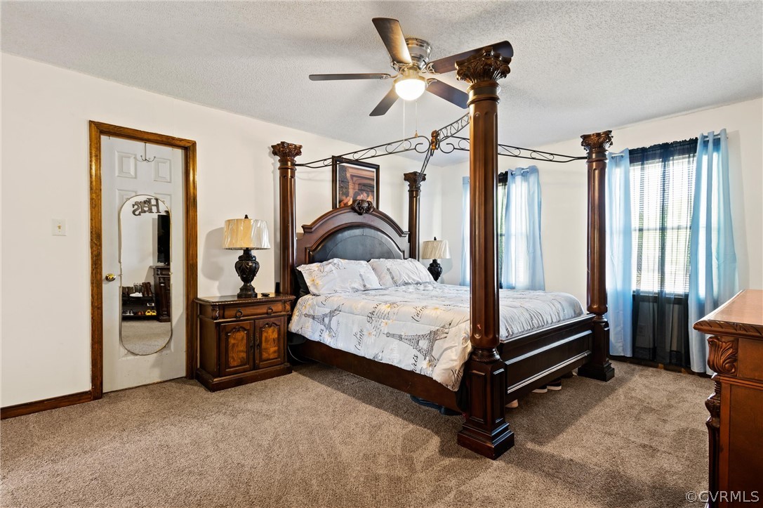 7329 Trailing Rock Road Prince George, VA 23875 - Photo 18 of 28 a bedroom with a bed lamp closet and large window