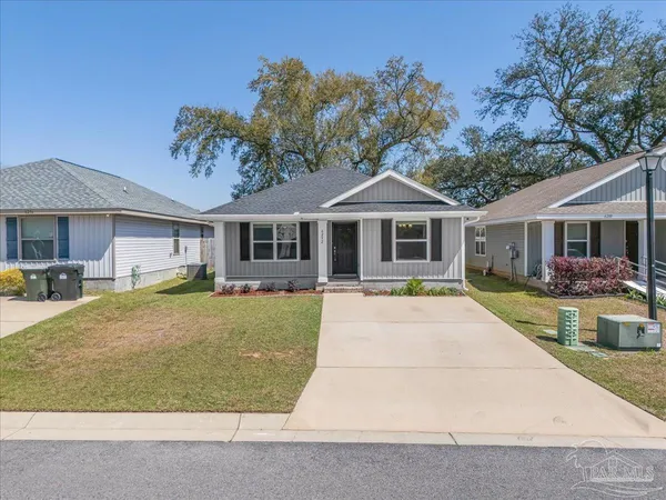 a front view of a house with yard patio and swimming pool