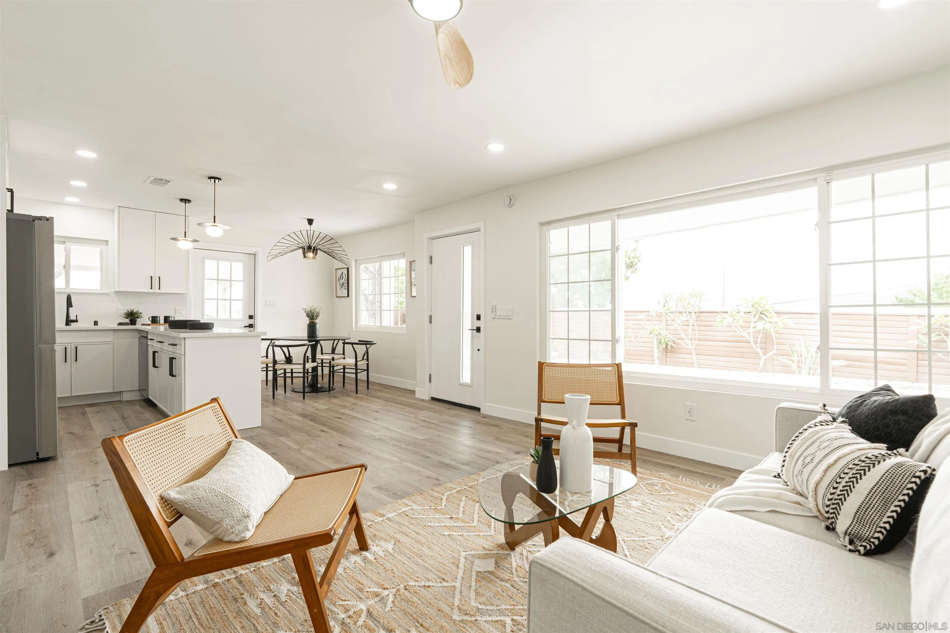 9376 Starcrest Drive Santee, CA 92071 - Photo 11 of 39 a living room with furniture and a large window with kitchen view
