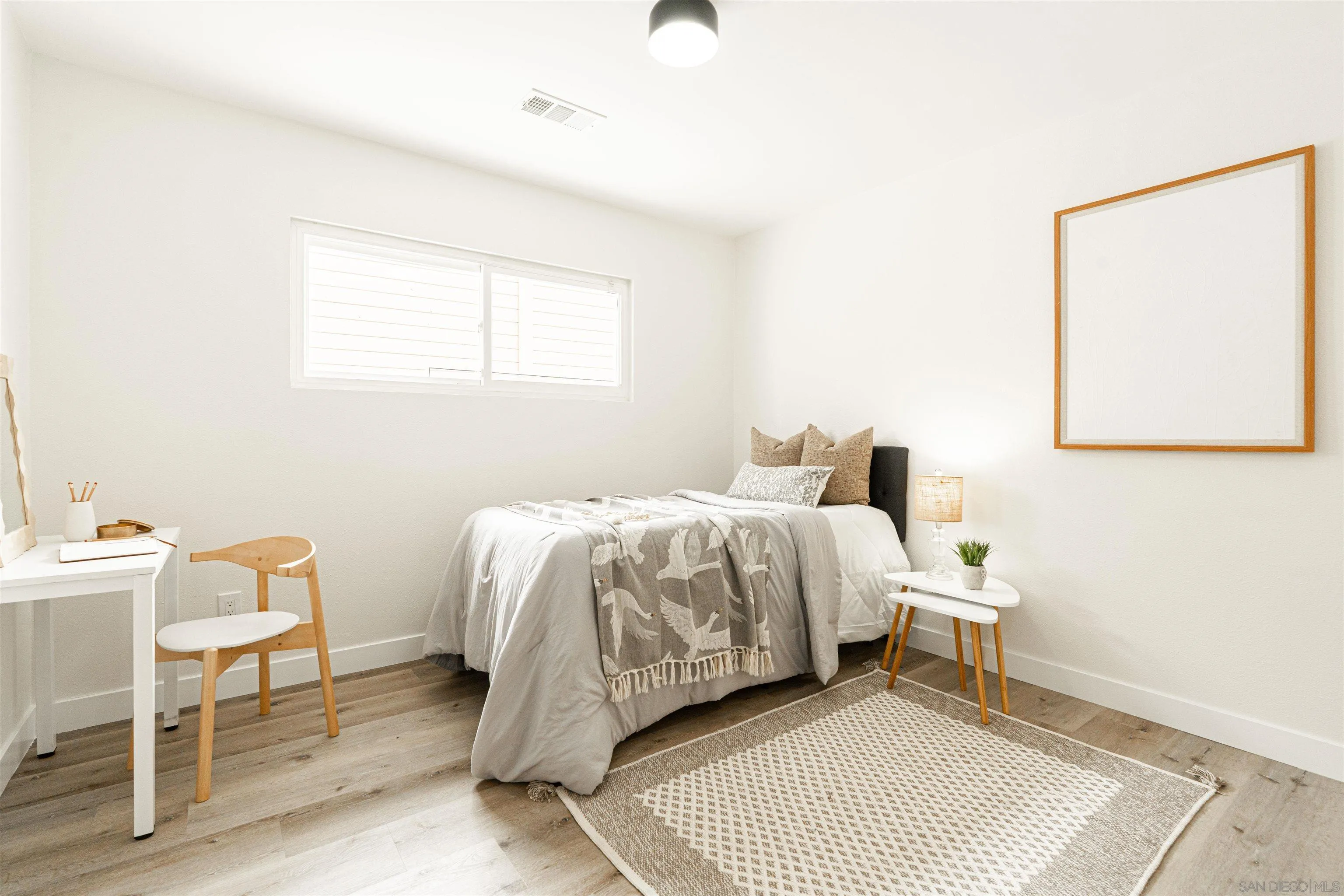 9376 Starcrest Drive Santee, CA 92071 - Photo 14 of 39 a bedroom with a bed and a chair