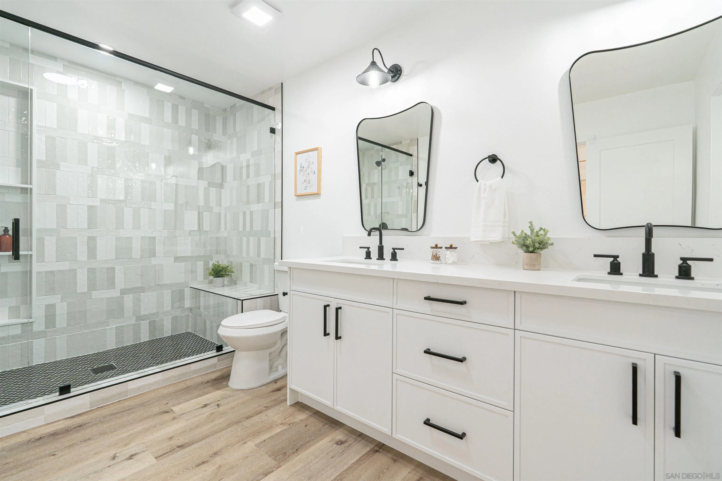 9376 Starcrest Drive Santee, CA 92071 - Photo 17 of 39 a bathroom with a double vanity sink mirror and toilet