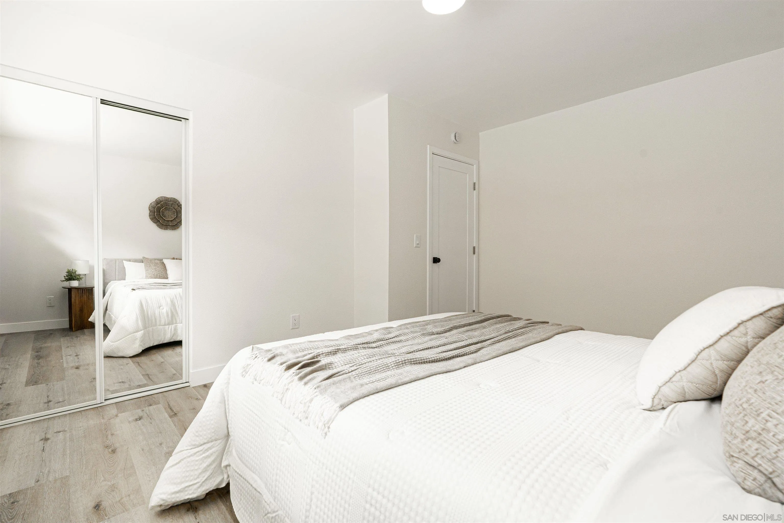 9376 Starcrest Drive Santee, CA 92071 - Photo 18 of 39 a bedroom with a bed and a lamp