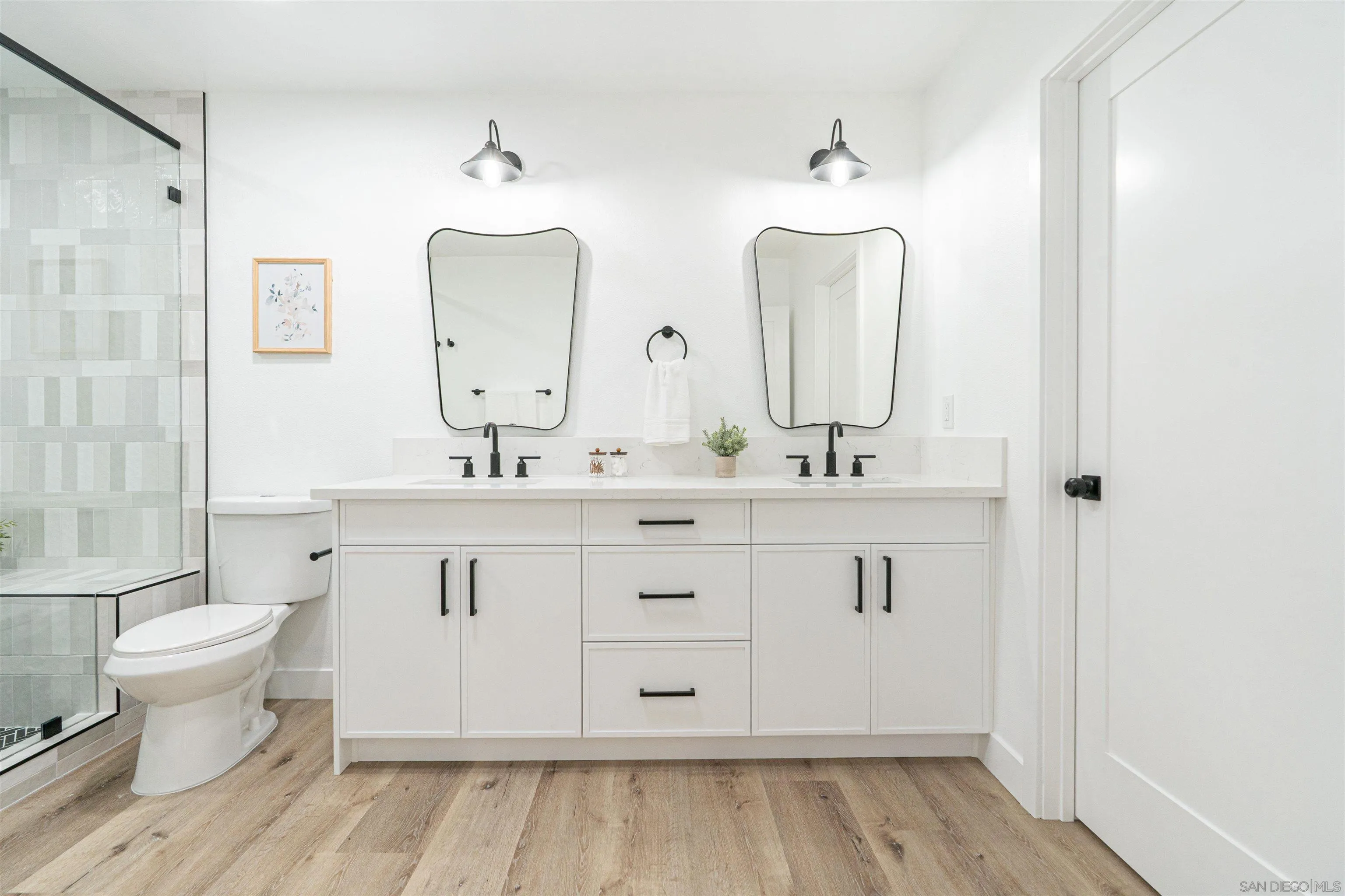 9376 Starcrest Drive Santee, CA 92071 - Photo 22 of 39 a bathroom with a double vanity sink mirror and toilet